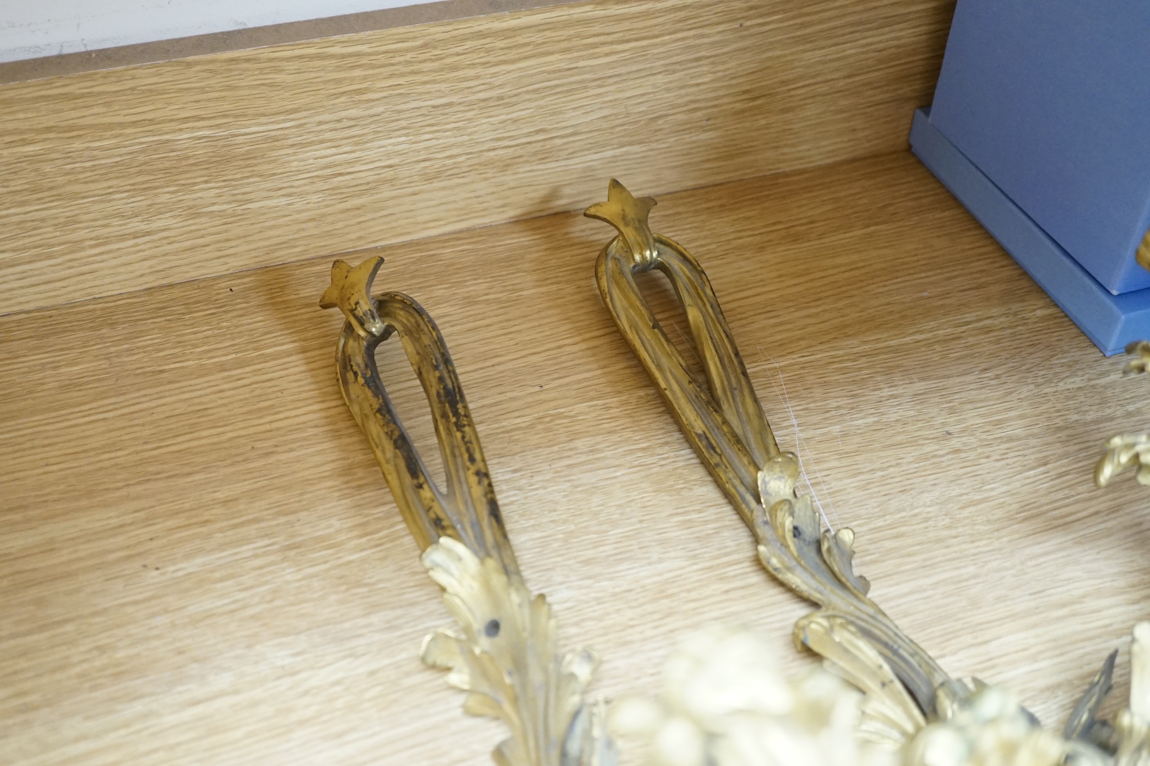 A pair of rococo style ormolu two branch wall lights, 76cm